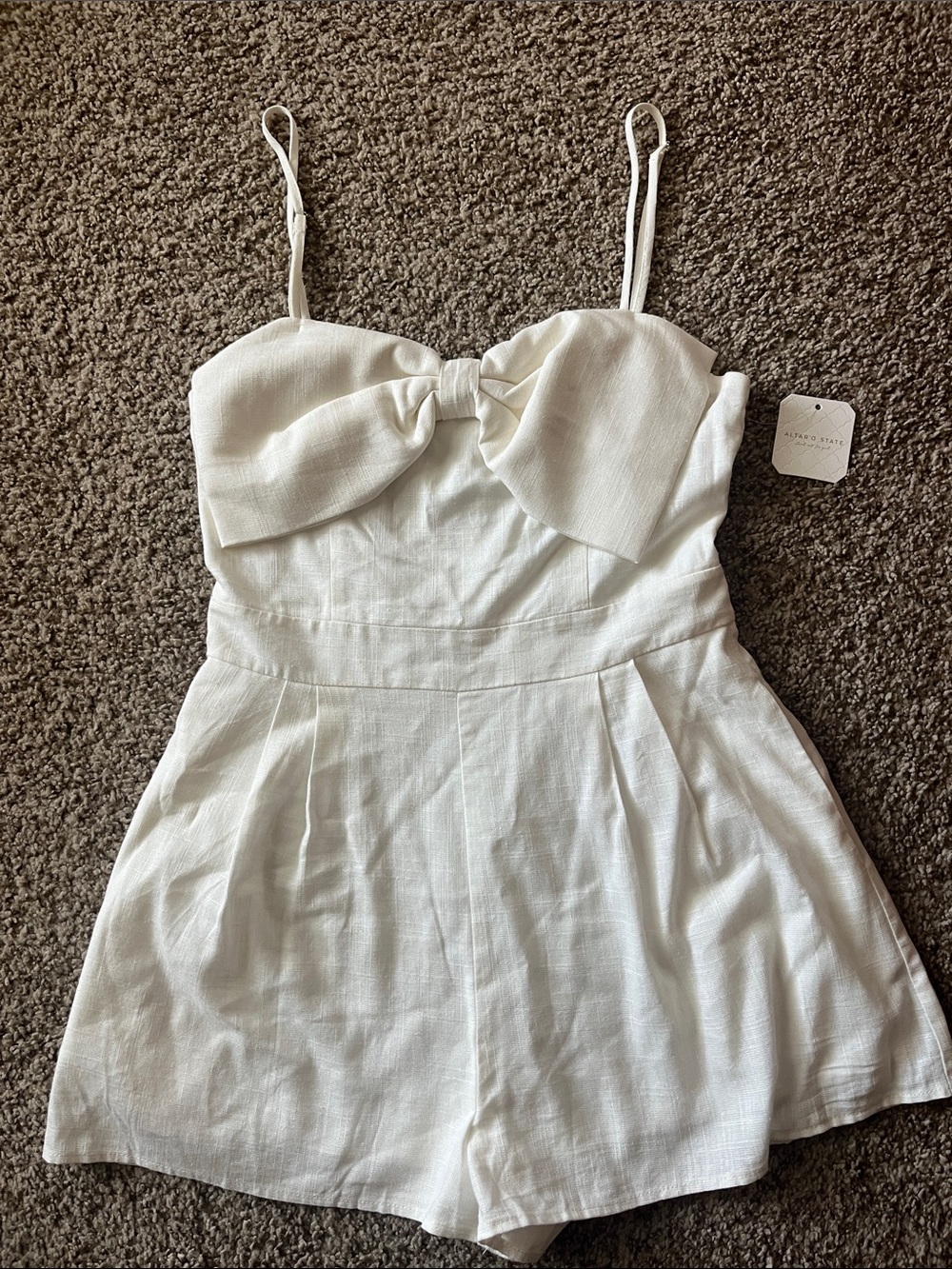 Altar'd State White Spaghetti Strap Romper with Front Bow Detail.  Size medium